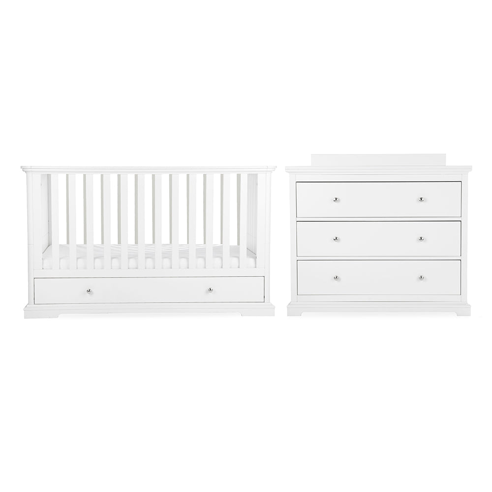 White baby furniture set including a convertible crib with built-in storage drawer and a matching three-drawer dresser, cuddle co kaliedy
